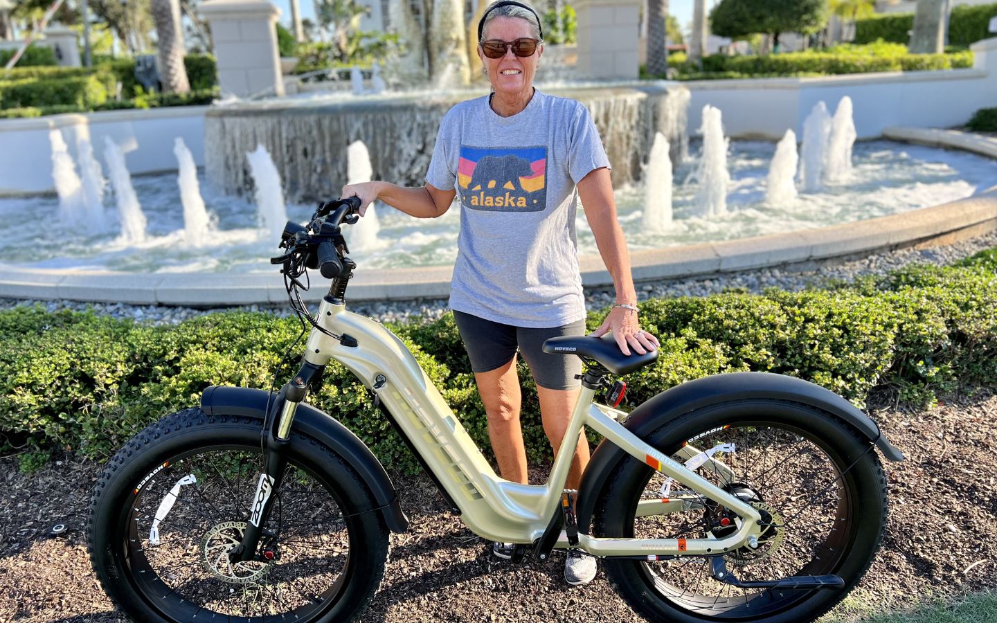 A-woman-stands-beside-a-Hovalpha-Champaign-ebike